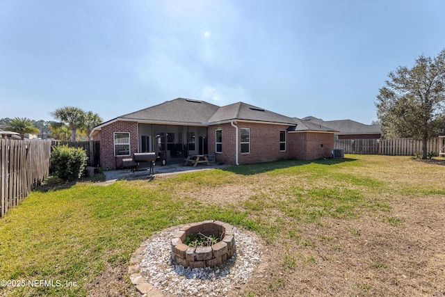 back of house with a patio, brick siding, and a fenced backyard