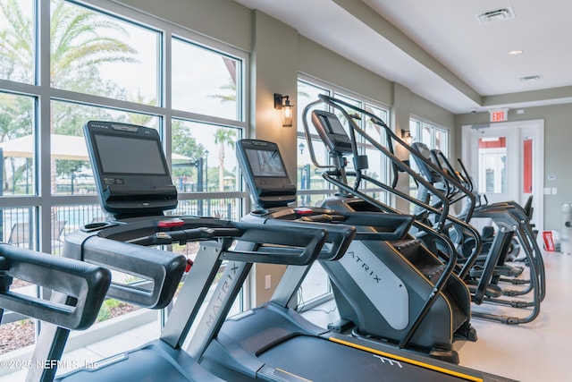 exercise room with a healthy amount of sunlight and visible vents