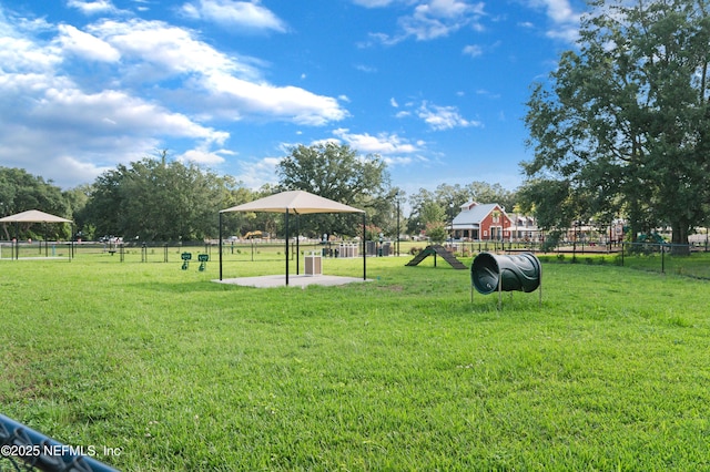 surrounding community with a yard and fence