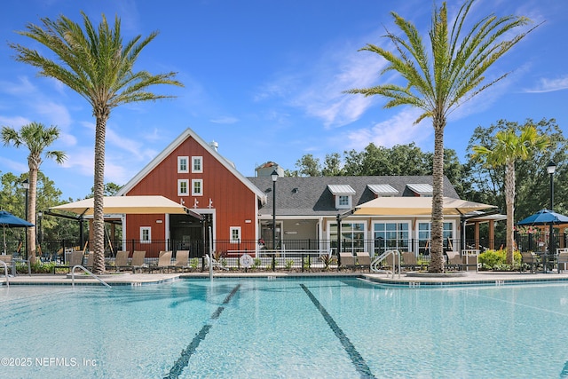 community pool featuring a patio and fence