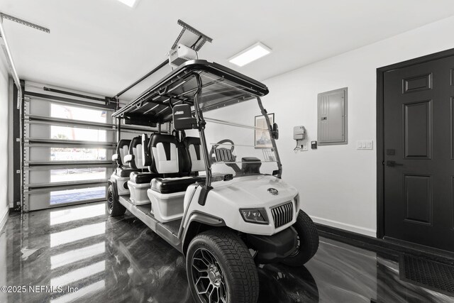 workout room featuring a garage, electric panel, and baseboards