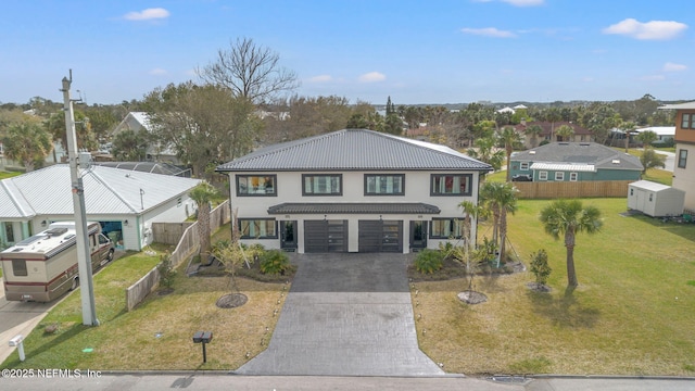 view of front facade with a garage, a tile roof, fence, decorative driveway, and a front lawn