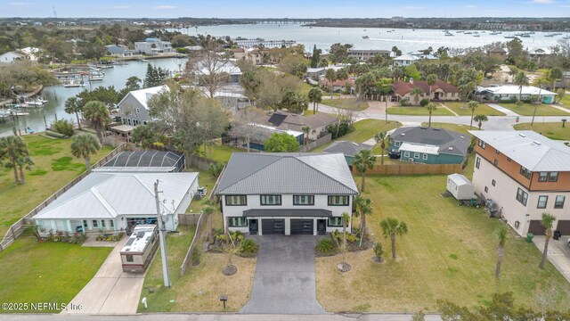 birds eye view of property with a water view and a residential view