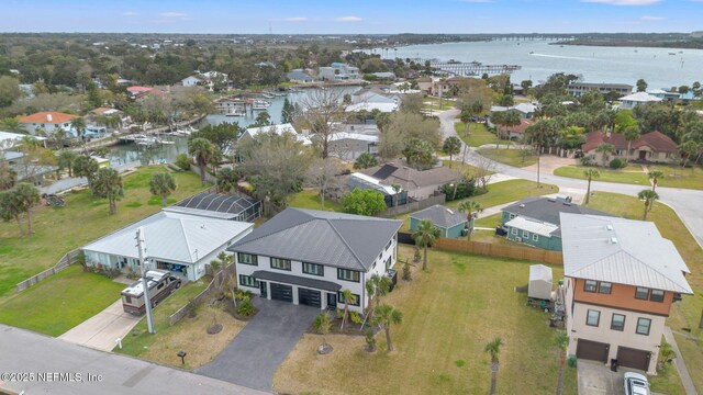 drone / aerial view with a water view and a residential view