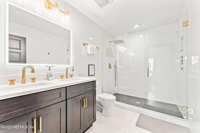 full bath featuring toilet, a stall shower, a sink, and visible vents