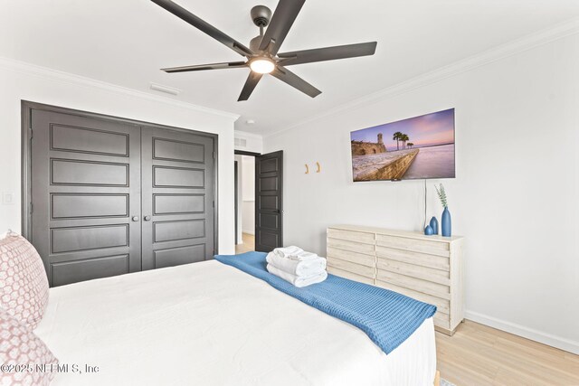 bedroom featuring ornamental molding, ceiling fan, baseboards, and wood finished floors