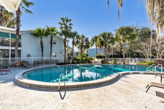 pool featuring a patio and fence