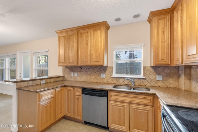 kitchen featuring light tile patterned flooring, a peninsula, a sink, stainless steel dishwasher, and decorative backsplash