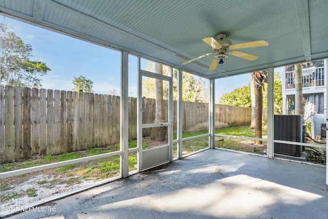 unfurnished sunroom with a ceiling fan