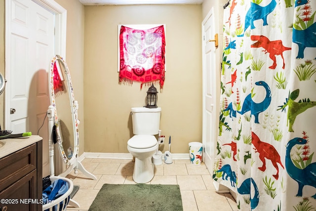 bathroom featuring baseboards, toilet, curtained shower, tile patterned flooring, and vanity