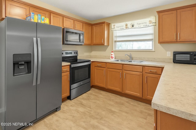 2277 Stauffer Rd, Green Cove Springs, FL 32043 - kitchen featuring appliances with stainless steel finishes, light countertops, and brown cabinets