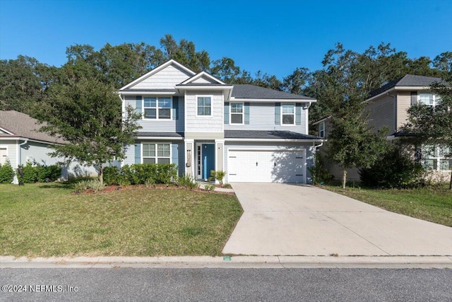 view of front of home with a garage, concrete driveway, and a front yard