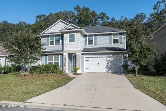 traditional home with a front yard, concrete driveway, and an attached garage