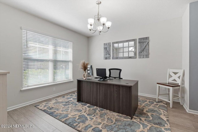 office with a chandelier, wood finished floors, and baseboards