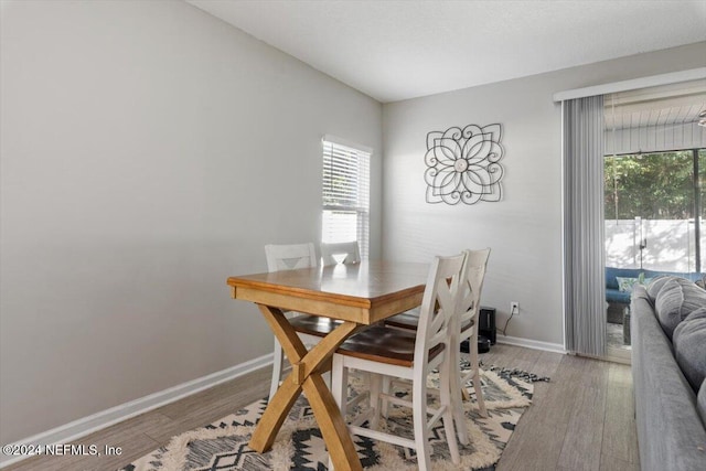 dining space featuring a healthy amount of sunlight, baseboards, and wood finished floors