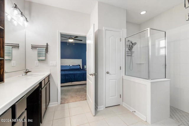 full bathroom with ensuite bathroom, tile patterned flooring, vanity, a ceiling fan, and walk in shower