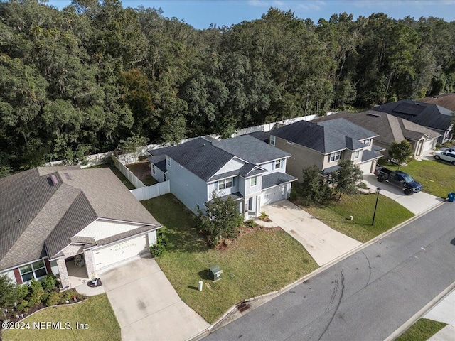 birds eye view of property featuring a wooded view and a residential view