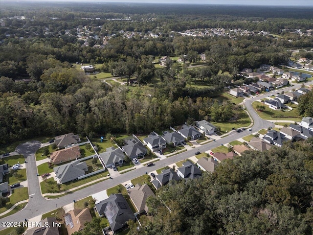 aerial view with a wooded view and a residential view