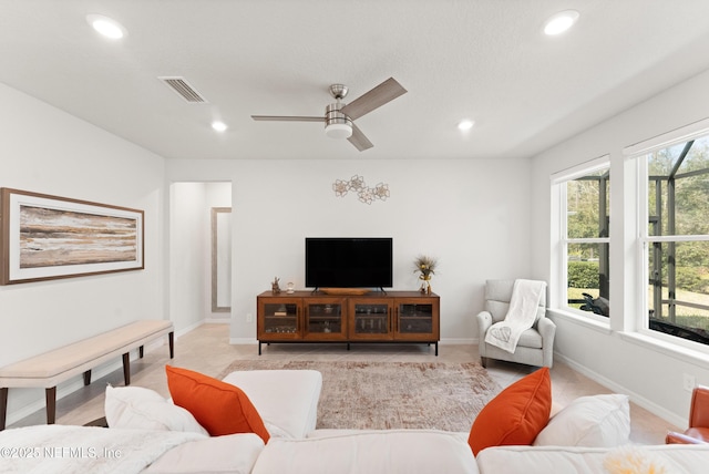 living area with recessed lighting, visible vents, and baseboards