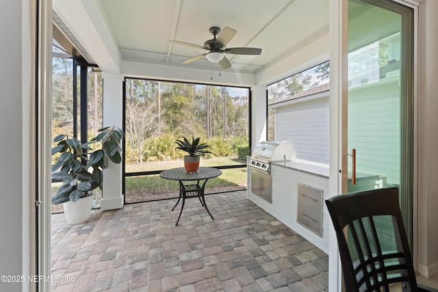 sunroom with a ceiling fan