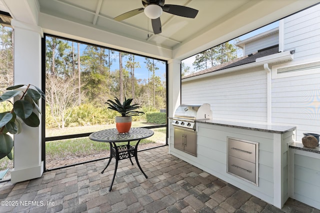 sunroom with a ceiling fan