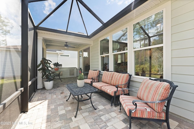 sunroom / solarium featuring a ceiling fan and plenty of natural light