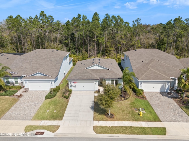 birds eye view of property with a wooded view