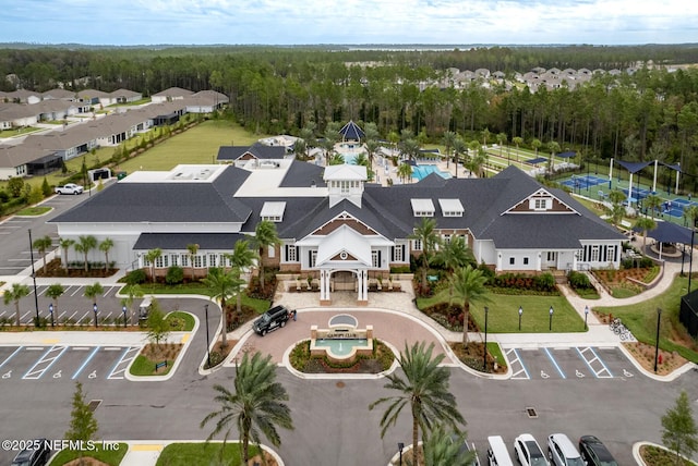 bird's eye view featuring a forest view and a residential view