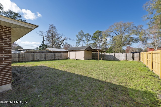 view of yard with a fenced backyard, a storage unit, and an outdoor structure