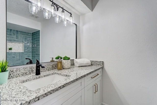 bathroom with visible vents and vanity