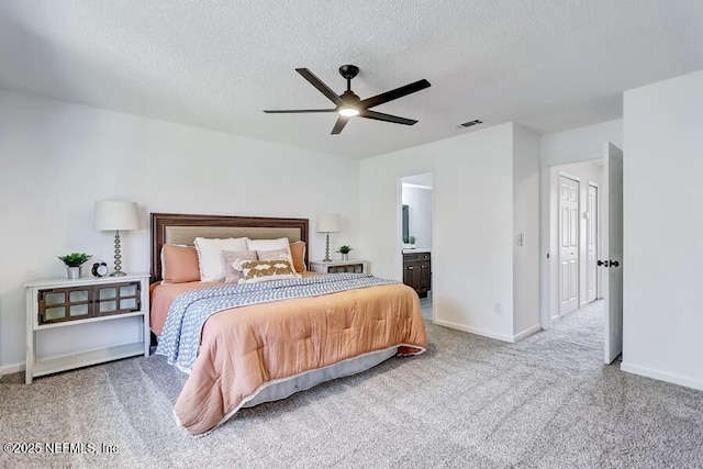 bedroom featuring carpet floors, visible vents, baseboards, and a textured ceiling