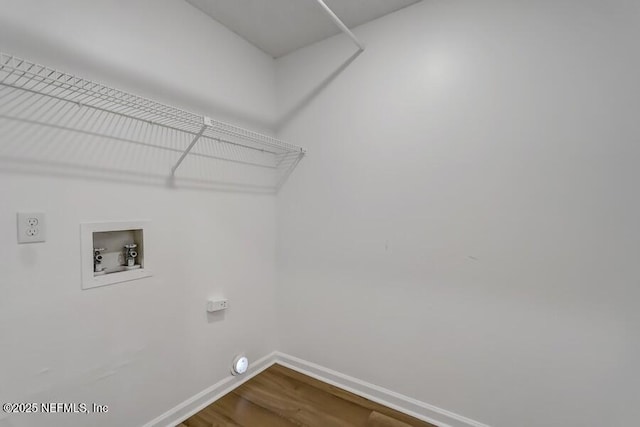 laundry area with hookup for an electric dryer, laundry area, dark wood-type flooring, washer hookup, and baseboards