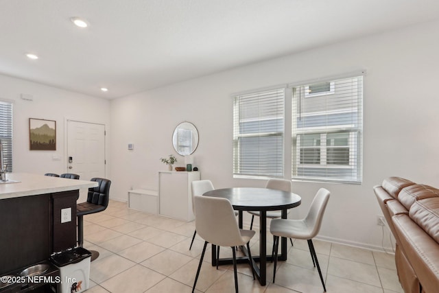 dining space featuring baseboards, light tile patterned flooring, and recessed lighting