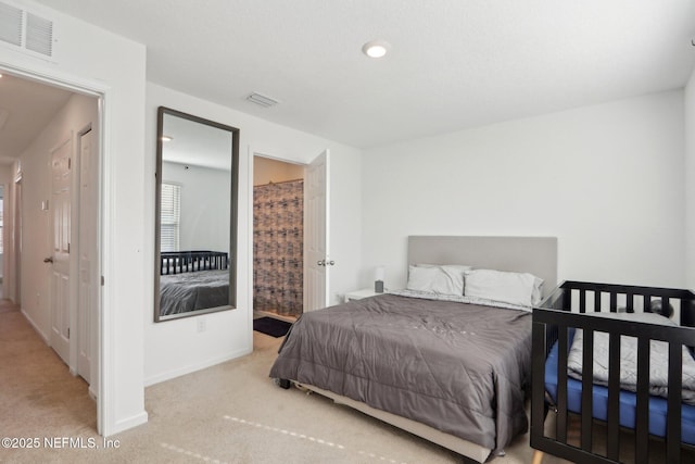 bedroom with carpet floors, visible vents, and baseboards