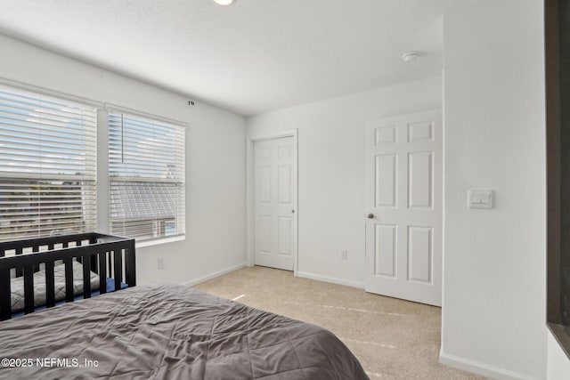 bedroom featuring carpet flooring and baseboards