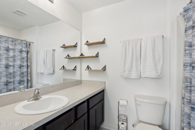 full bath featuring toilet, visible vents, and vanity