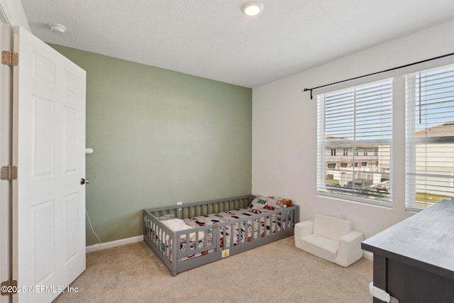 carpeted bedroom featuring baseboards