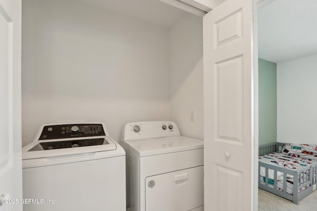 laundry area with laundry area, light colored carpet, and separate washer and dryer