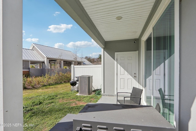 exterior space featuring cooling unit and fence