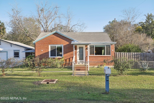 bungalow-style house with brick siding, a front yard, and fence