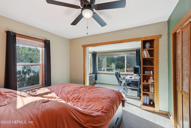 bedroom with baseboards, carpet floors, and ceiling fan