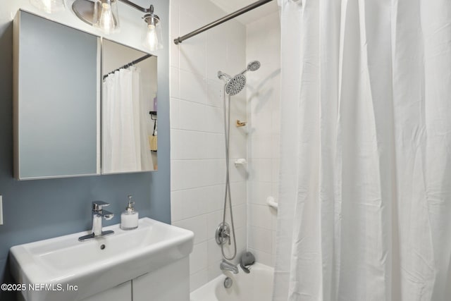 full bath featuring shower / bath combination with curtain and a sink