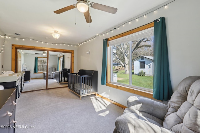 bedroom featuring track lighting, visible vents, and light carpet