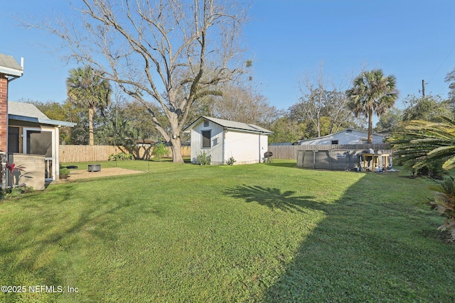 view of yard featuring a fenced backyard, a storage shed, and an outdoor structure