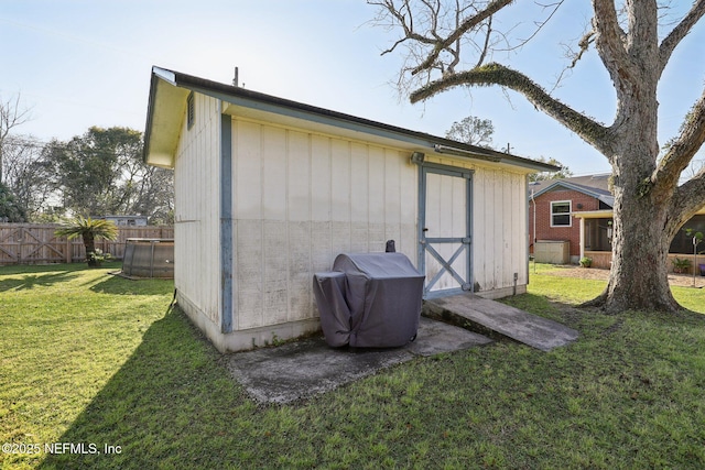 view of shed featuring fence