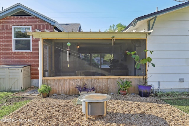 exterior space with brick siding and a sunroom