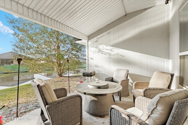 sunroom / solarium featuring vaulted ceiling and plenty of natural light