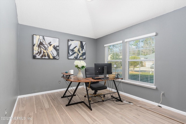 office with vaulted ceiling, baseboards, and wood finished floors