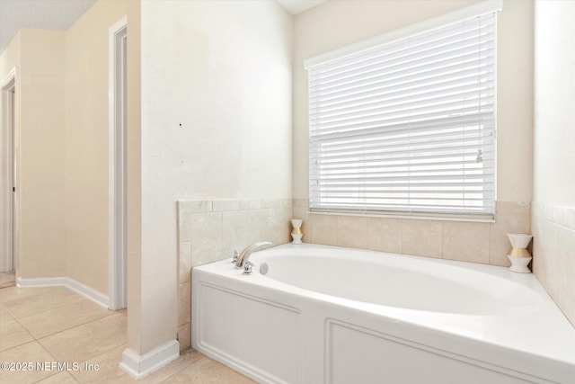 full bath featuring a garden tub and tile patterned floors