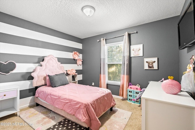 bedroom with light carpet, baseboards, and a textured ceiling